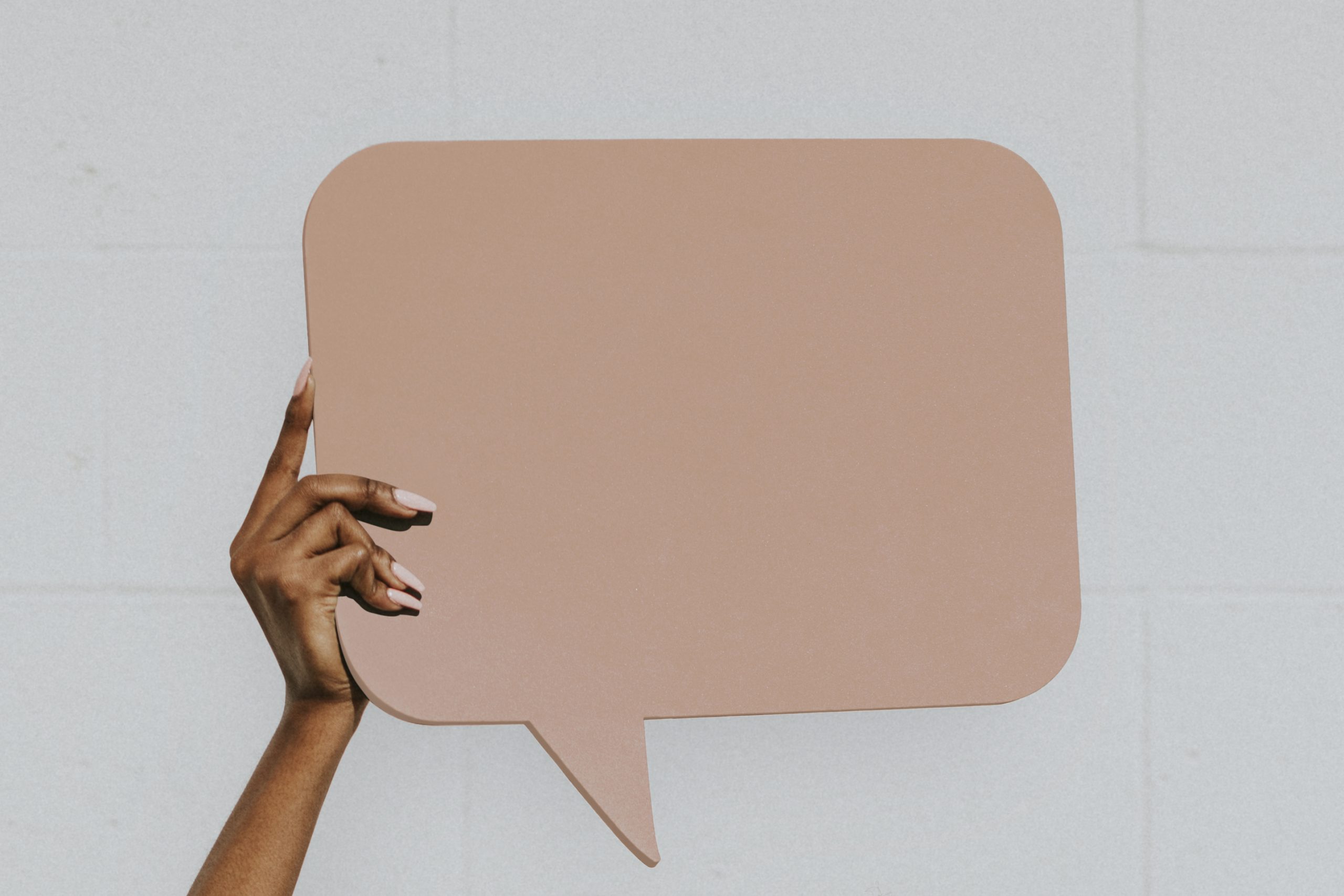 Hand showing a blank speech bubble